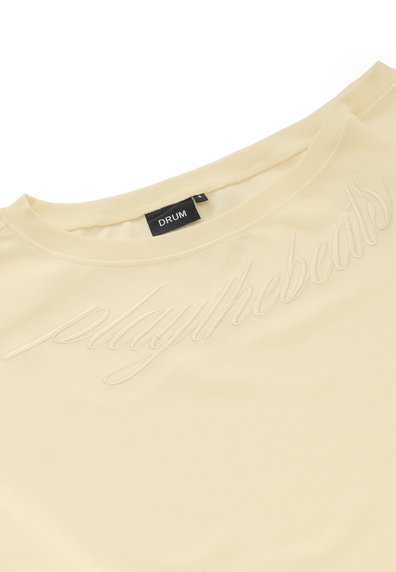 DRUM S. Women Asymmetrical Slogan Embroidery Jumper- Beige